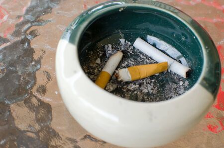Bad addiction. Ashtray and cigarettes close-up.の写真素材