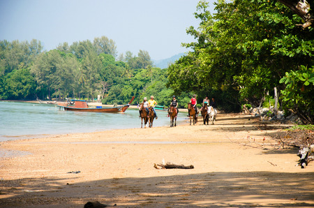 THAILAND, KARBI, FEBRUARY 24 2016.Tourists riding rented horses along the Ao Nang  beach Krabi  ,Thailand on February 24,2016のeditorial素材