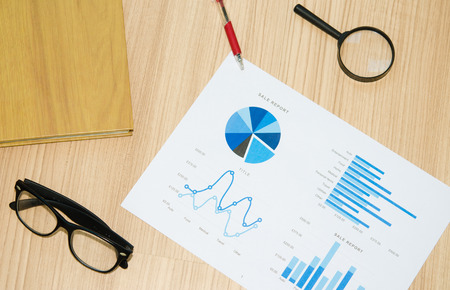 documents graph and book on wood.の写真素材