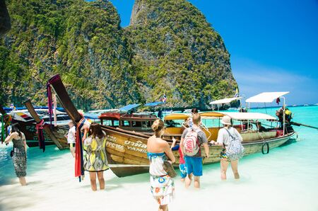 PHI PHI ISLANDS, THAILAND - CIRCA MARCH 03, 2016: Tourists relax on the beach of Maya Bay on Phi Phi Leh island.one of the iconic beaches of Phi Phi islands of Southern Thailand.のeditorial素材
