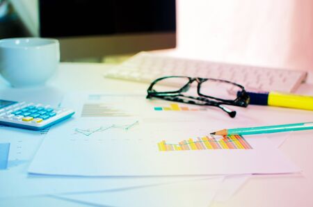 Office table with blank notepad and laptopの写真素材