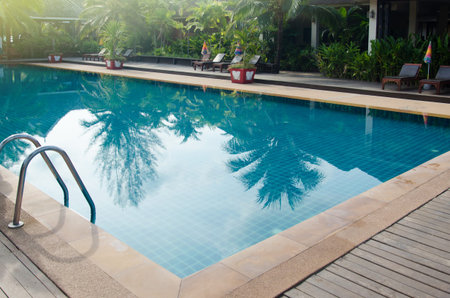 chair around swimming pool in hotel resort