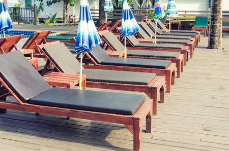 chair around outdoor swimming pool in hotel resort