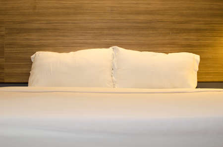 white pillows on bed in modern bedroom at homeの写真素材
