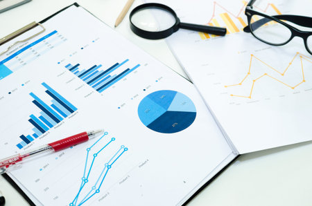 Business diagramme with magnifying glass
