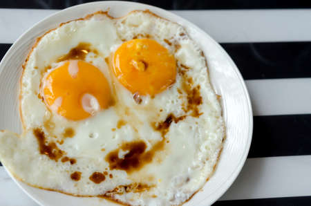 Close up view of the fried egg on a dish.の写真素材