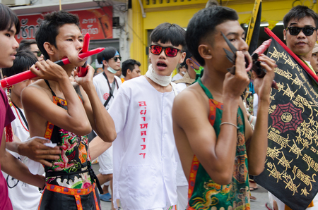 PHUKET , THAILAND - OCT 6, 2016: Unidentified  Taoist devotee joins a procession of the Phuket Vegetarian Festival. The event is famous for its spirit mediums who undergo ritual mutilation and piercing.のeditorial素材