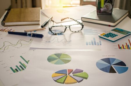 Graph paper and charts on a desk.の写真素材