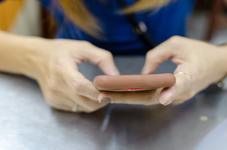 Closeup woman hand typing on smart phone