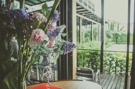 Vintage Flowers in a vase by the window.の写真素材