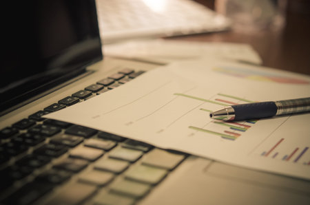 documents on office table with laptop computer and graph financial with social network diagram - Filter vintageの写真素材