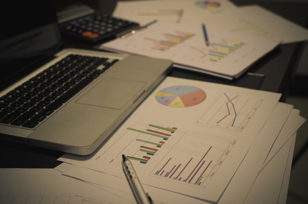 documents on office table with laptop computer and graph financial with social network diagram - Filter vintageの写真素材