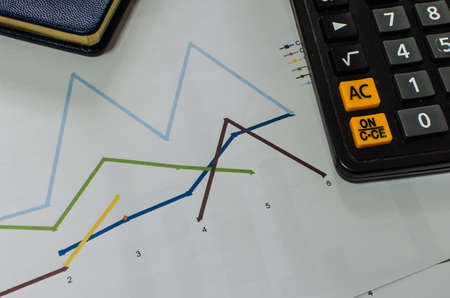 financial report with pen and calculator at the officeの写真素材