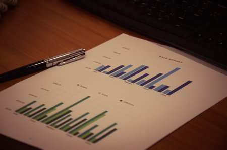 Black pen on paper, colorful graphs at work.
