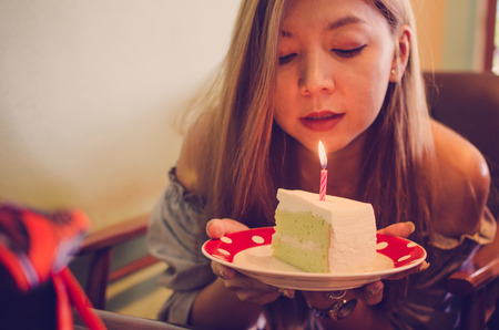 Girl with coconut birthday cake, vintage tone.の写真素材