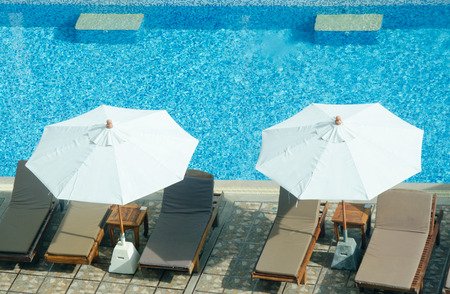Beautiful luxury umbrella and chair decoration swimming pool in hotel.の写真素材