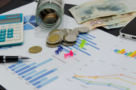 Business document analysis  with pen, report ,calculator on desk.