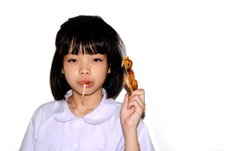 Girl eats chickens isolated on the white background,の写真素材