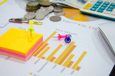 business documents on  table with mouse computer and coins and graph financial diagram.の写真素材