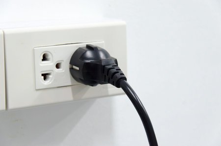 White electric plugs on wall background.