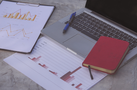 Financial chart with computer laptops and notebooks.の写真素材