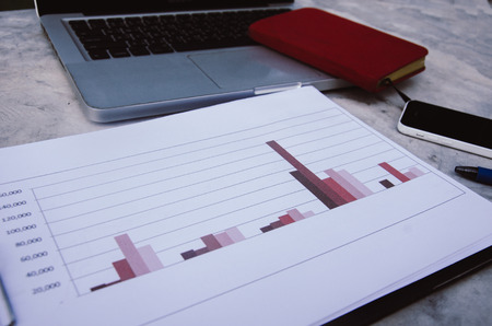 Financial chart with computer laptops and notebooks.の写真素材