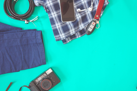 The concept of travel. Out of the traveler accessories. Flat lay traveler on a green background with copy space. Vintage toneの写真素材