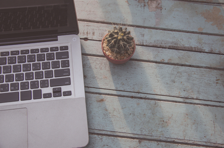 Notebook on wooden tables and cactus vintage tone.の写真素材