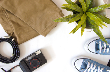 Brown pants, camera and shoes Travel accessories on a white background.の写真素材