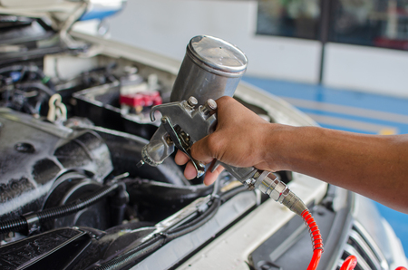 Man holding a car engine cleaning kit.の写真素材