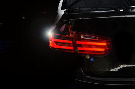 Luxury car tail light on a black background.の写真素材