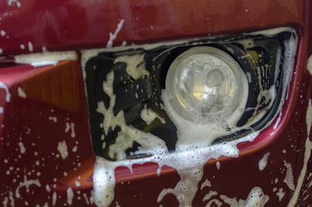 Car wash with foam in car washの写真素材