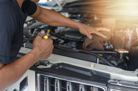 A man's hands, checking machine of automobile.の写真素材