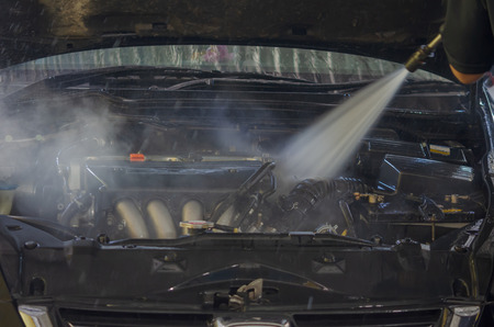 Car engine wash. Use high-pressure water spray.の写真素材