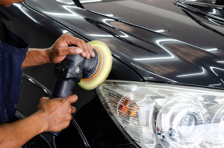 man hand cleaning the car with polishing and waxingの写真素材
