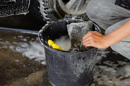 Clean the car wheels with car wash foam and black water tank.の写真素材