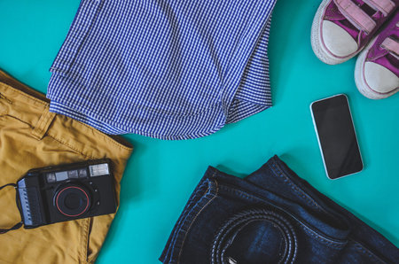Top view Accessories for travel. Smartphone clothing, sneakers and a camera. , Travel concept
