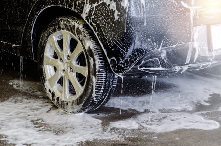 Car wash black with foam bubbles
