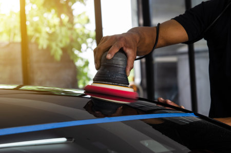 Man working for polishing, coating cars.の写真素材