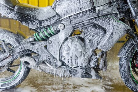 Bubble foam cleaning motorcycle washの写真素材