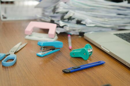 pile of papers and office equipment on desk.の写真素材