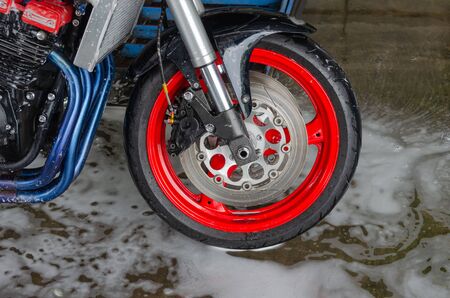 Bubble foam cleaning motorcycle washの写真素材