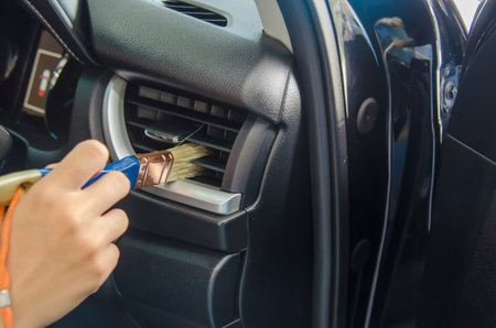 clean the car's air conditioner in the passenger room by using a dust brush to prevent dirt in the...