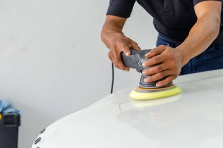Man working for polishing, coating cars. polishing of the car will help eliminate contaminants on the surface of the car.Waxing the car surface will cause shine after polishing the car.の写真素材
