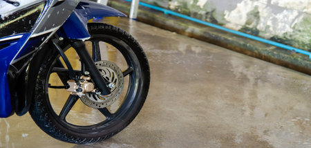 Wash motorcycle with foam at car wash station