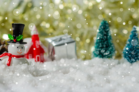 Snowman and Christmas tree on the snow.の写真素材