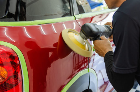 Man hands holding the work tool polish the car.Buffing and polishing car. Car detailing.
