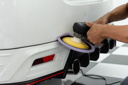 Man hands holding the work tool polish the car.Buffing and polishing car. Car detailing.