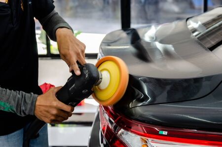 Man hands holding the work tool polish the car.Buffing and polishing car. Car detailing.の写真素材