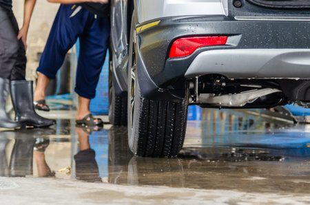 Wash the car at the station. Focus on the back of car